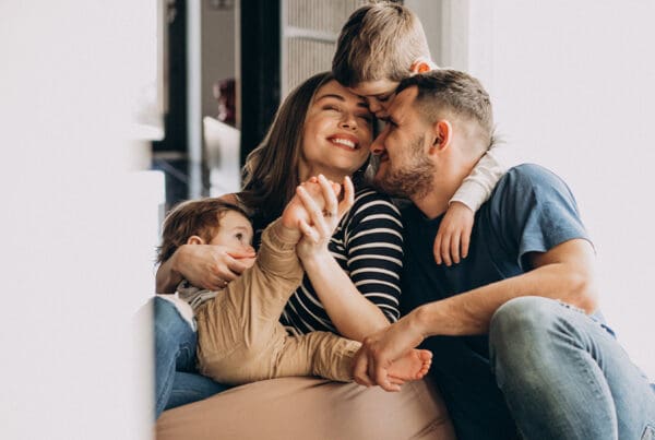 Life Insurance Insights - A Practical Guide for Financial Security - Young family with their sons at home having fun